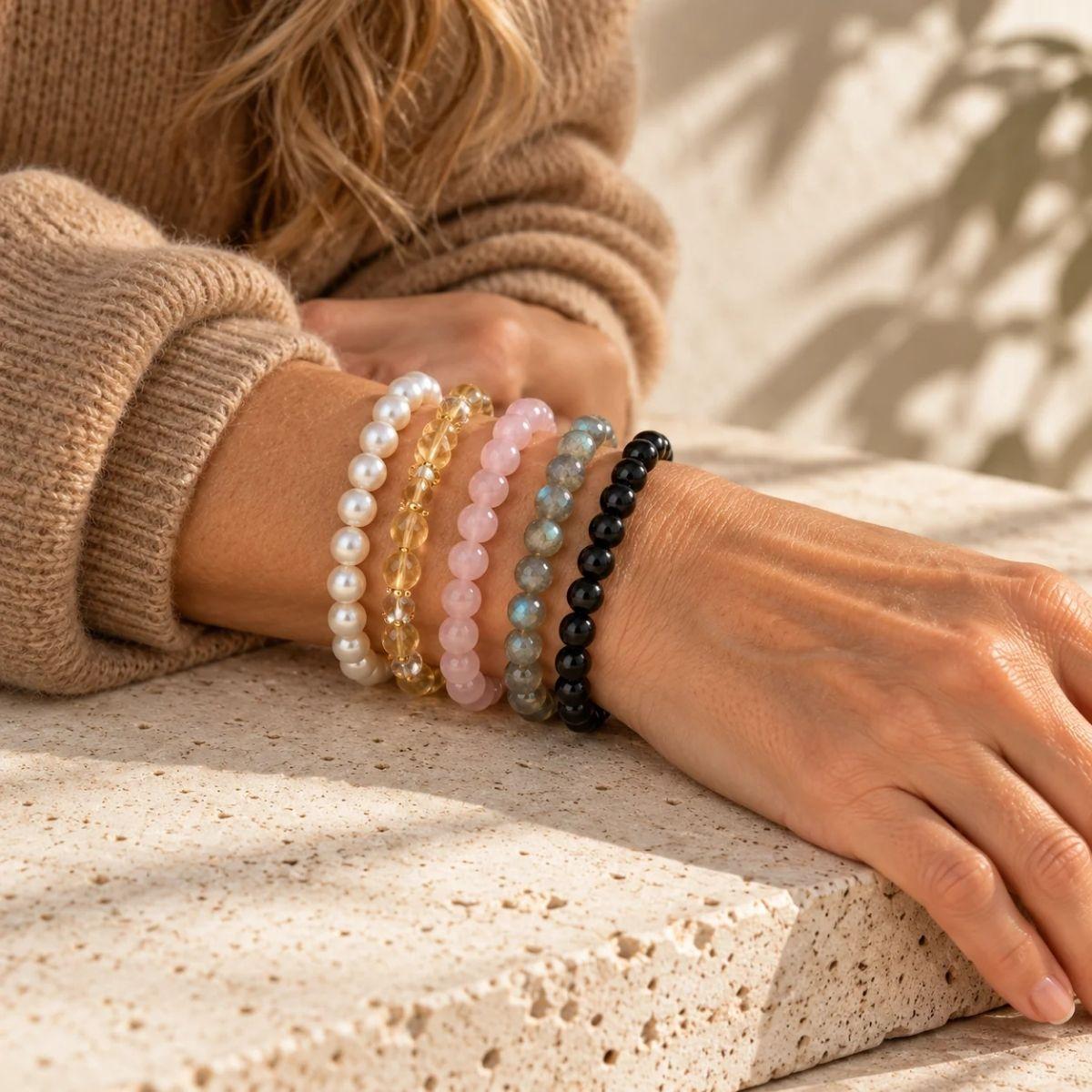 Five crystal bracelets stacked on one wrist — how to build a meaningful bracelet stack