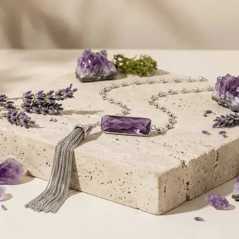 Silver amethyst tassel necklace on a pale background with lavender — February birthstone jewelry