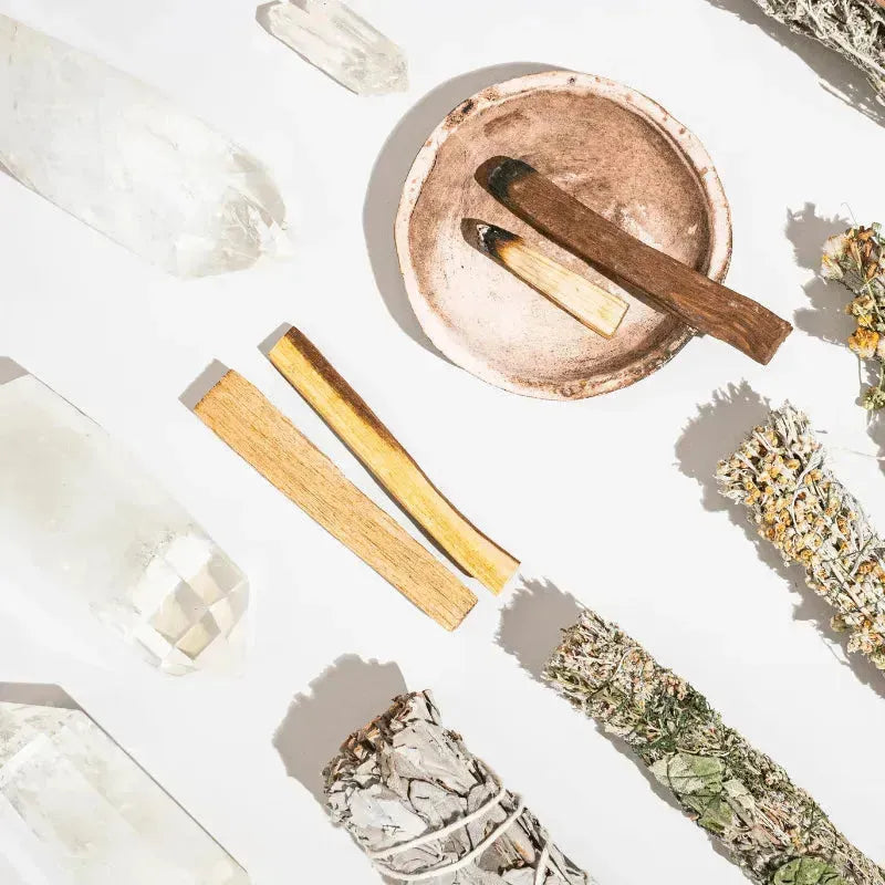 Jewelry laid out for a cleansing ritual with candle and smoke — moonlight, smoke and sound