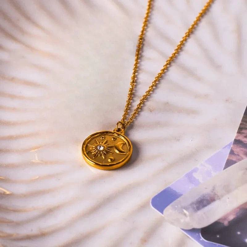 Gold necklace with a pendant on a seashell background