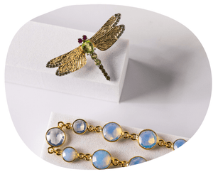 flat lay dragonfly pin with peridot and gold, opalite necklace
