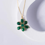 Gold-plated flower pendant necklace featuring an opaque emerald stone