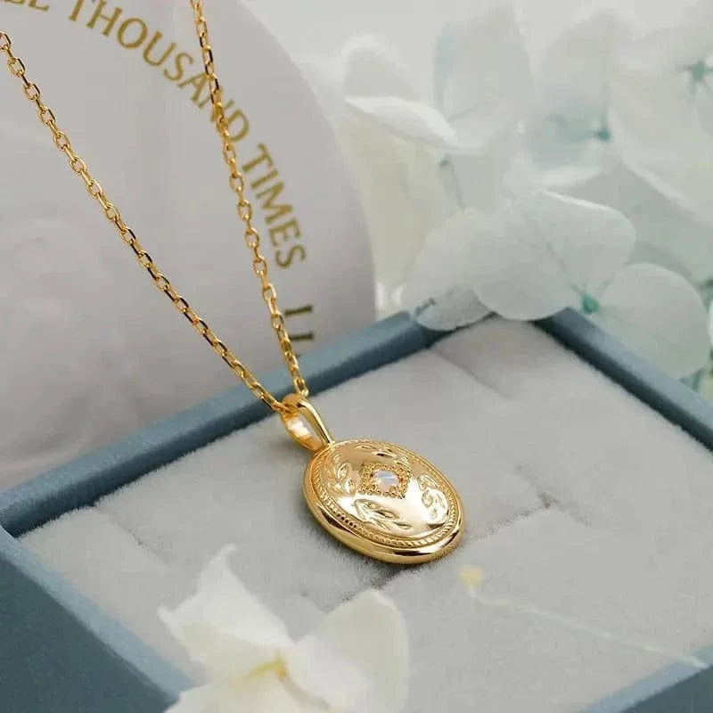 Gold necklace with a pendant on a soft surface