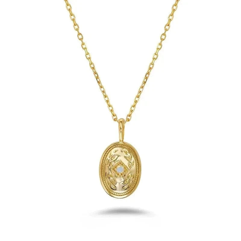 Gold necklace with an oval pendant on a white background