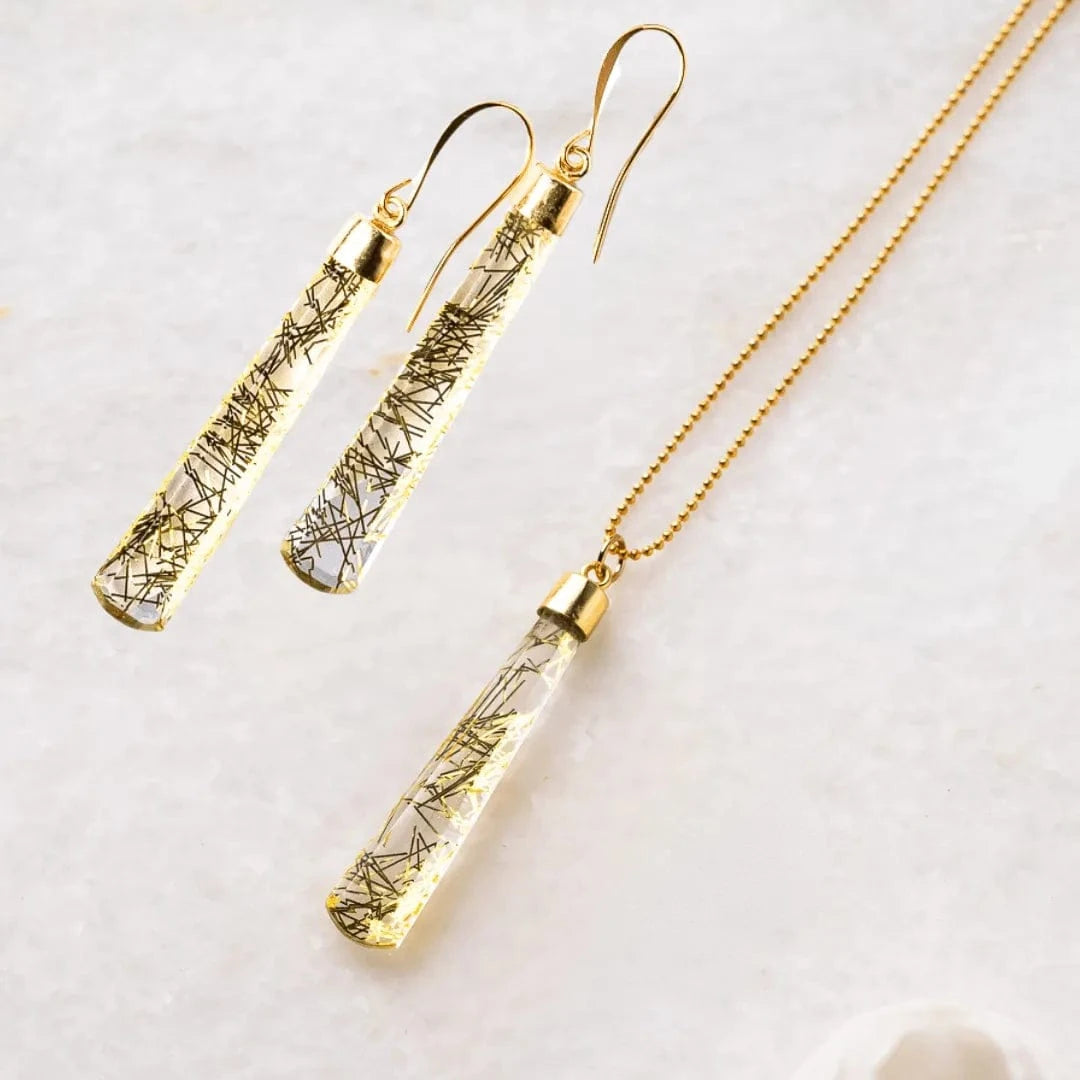Gold necklace and earrings on a white background