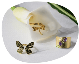 flat lay rings butterfly, dragonfly and tulip with cala lily