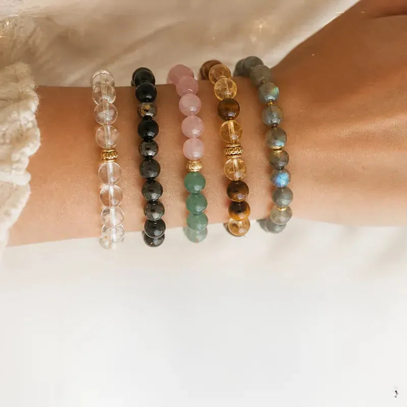 Crystal bead bracelets stacked on a wrist, how to build a meaningful bracelet stack