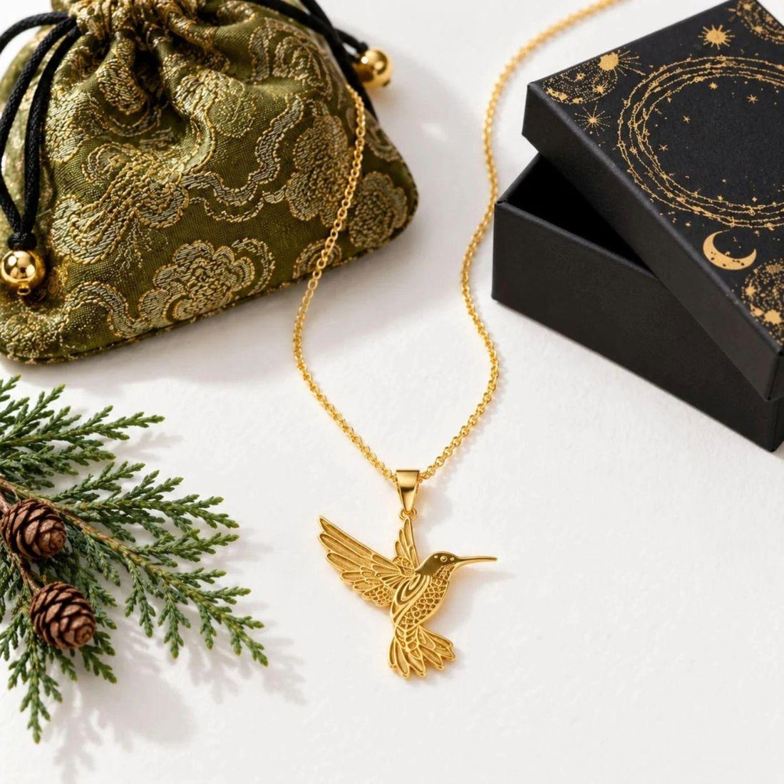 Gold hummingbird pendant with the Mystic Soul gift bag and celestial box — what to give someone having a hard year