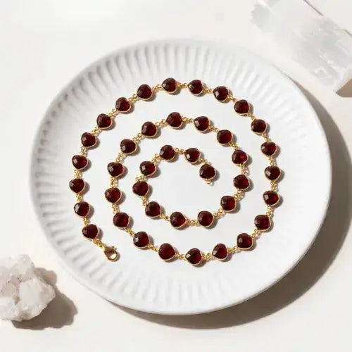 BLOG garnet necklace on white dish