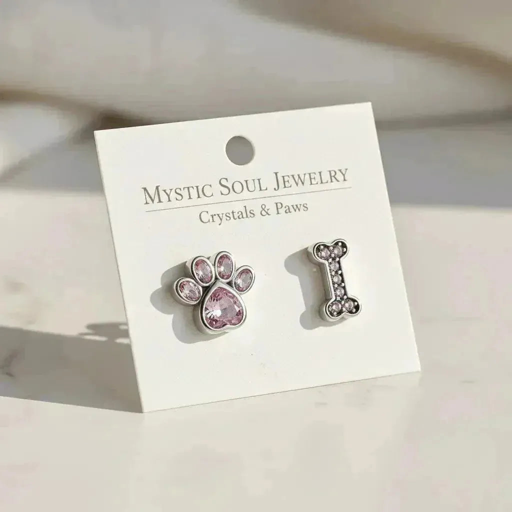 Sterling silver paw and bone stud earrings on a meaning card — Crystals & Paws jewelry