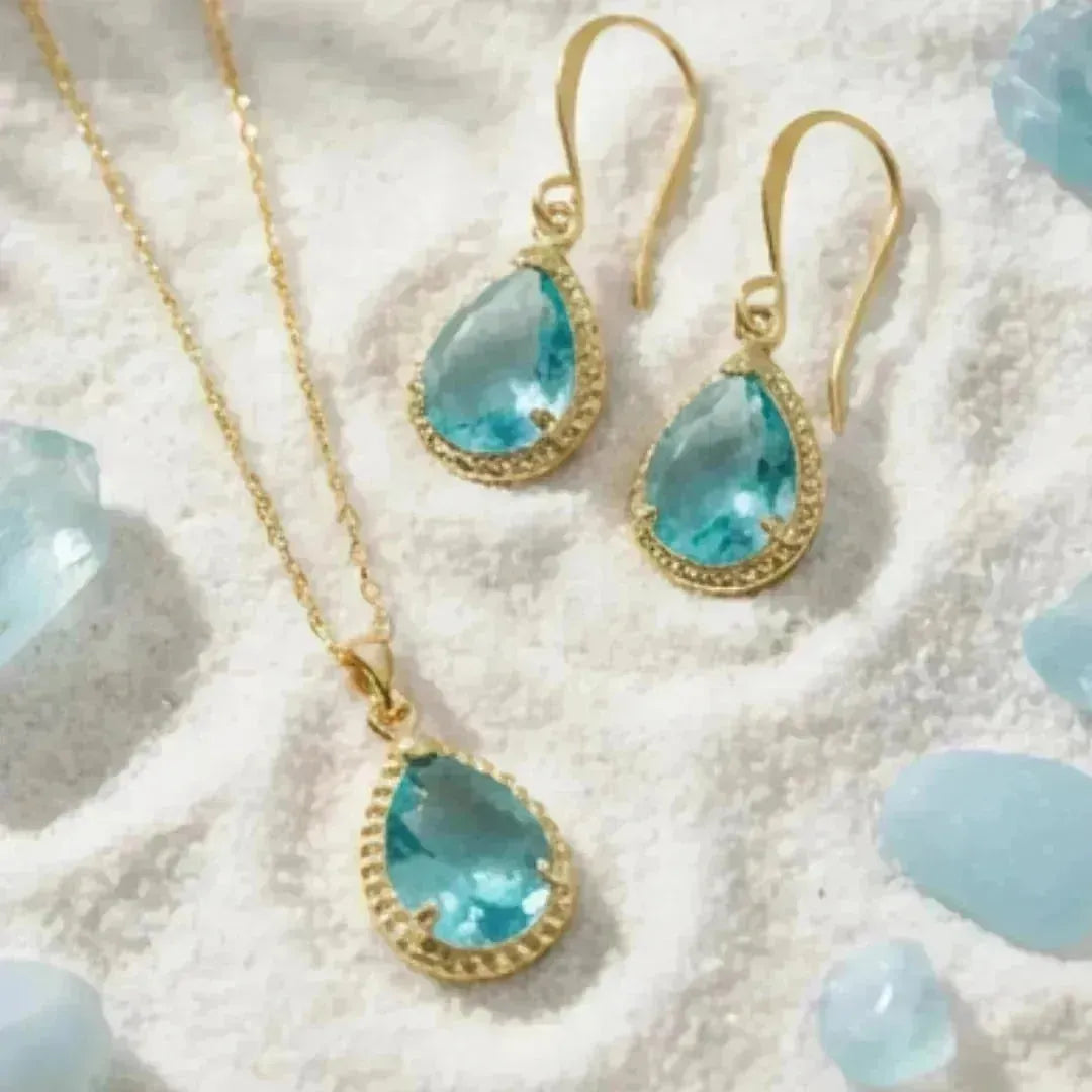 light colored sand with aqua blue exquisite necklace and earrings