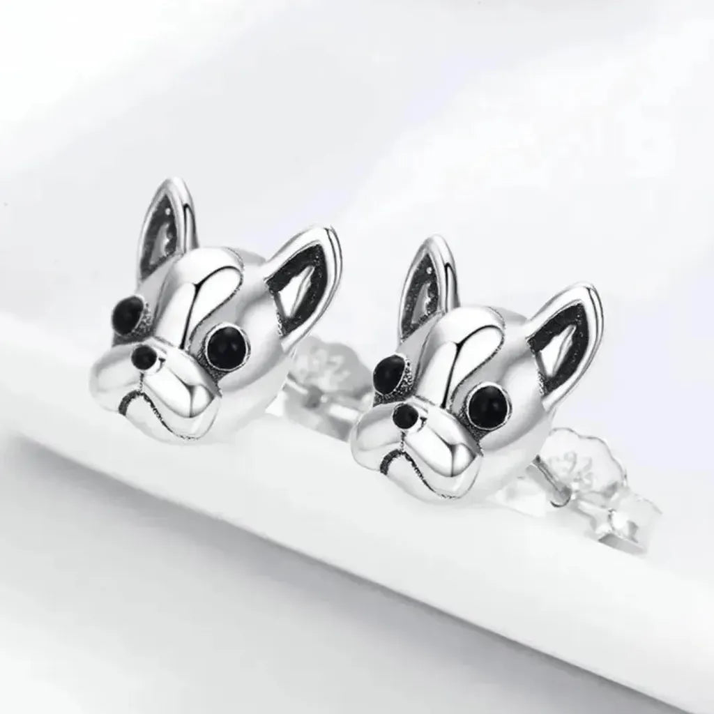 silver paw earrings on light background with dog bone dog tag and rose quartz