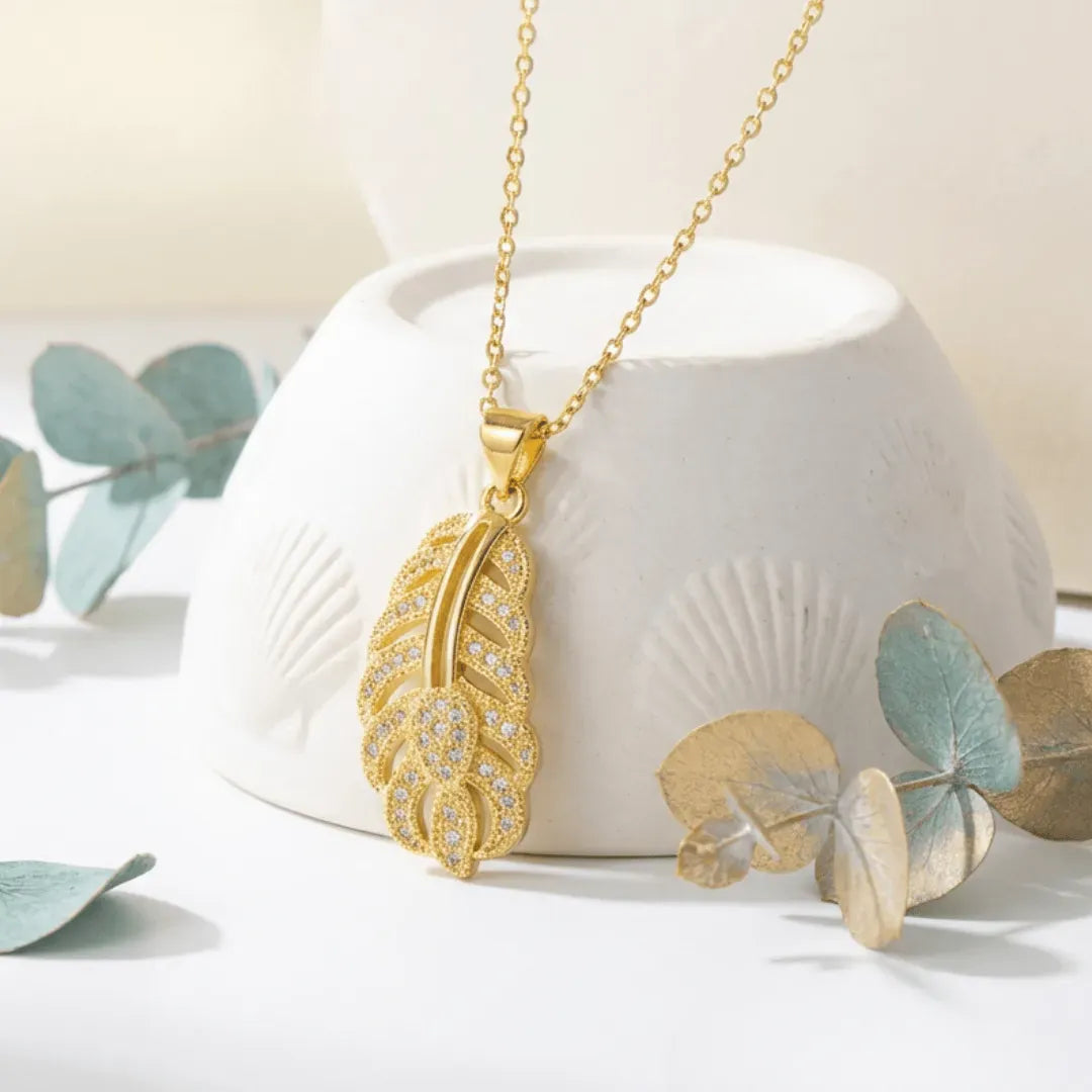 crystal gold leaf necklace on white background with leafs