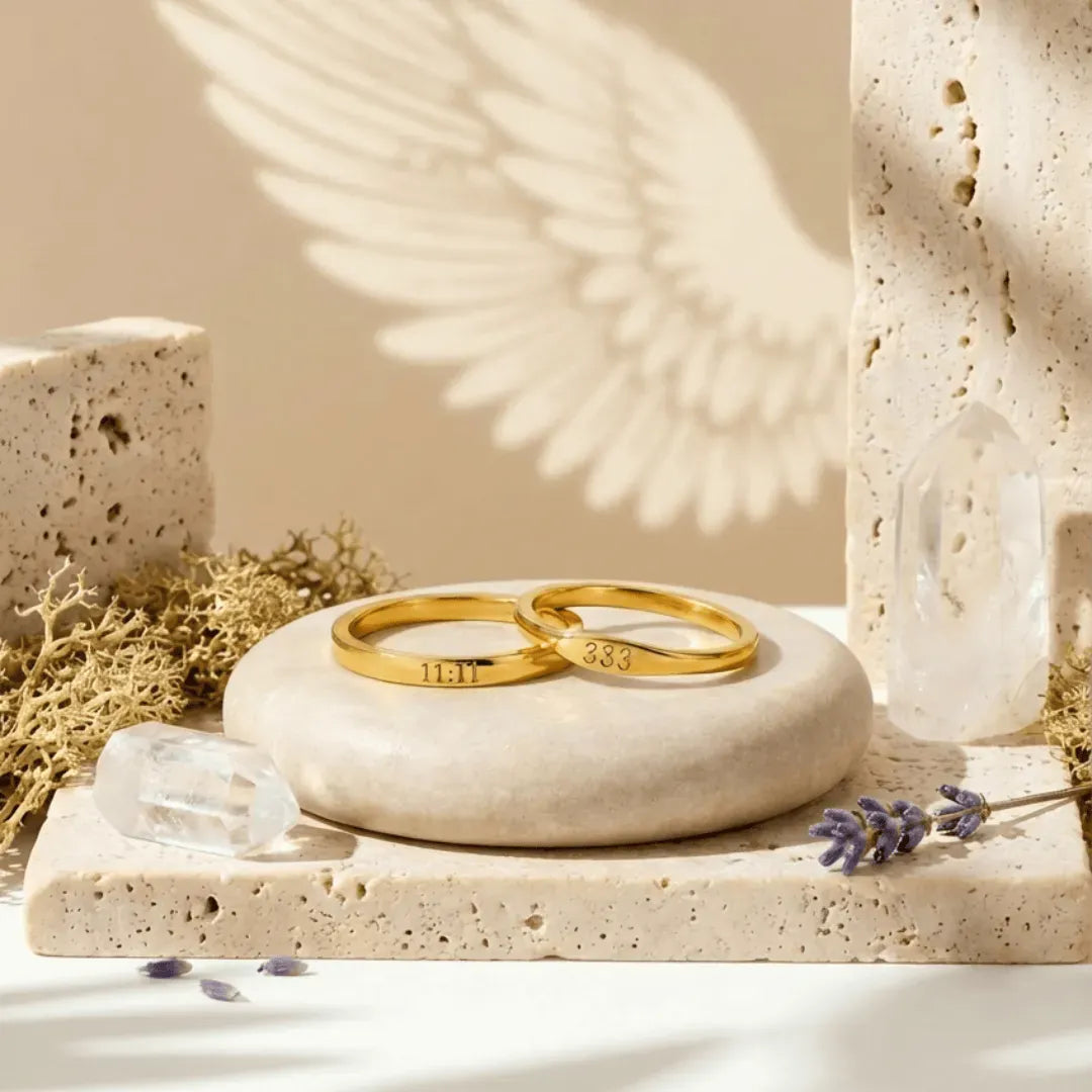 Two gold rings on a stone surface with a natural background