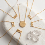 222 333 444 888 1111 Gold angel number pendant necklaces  stainless steel, displayed on stone surface