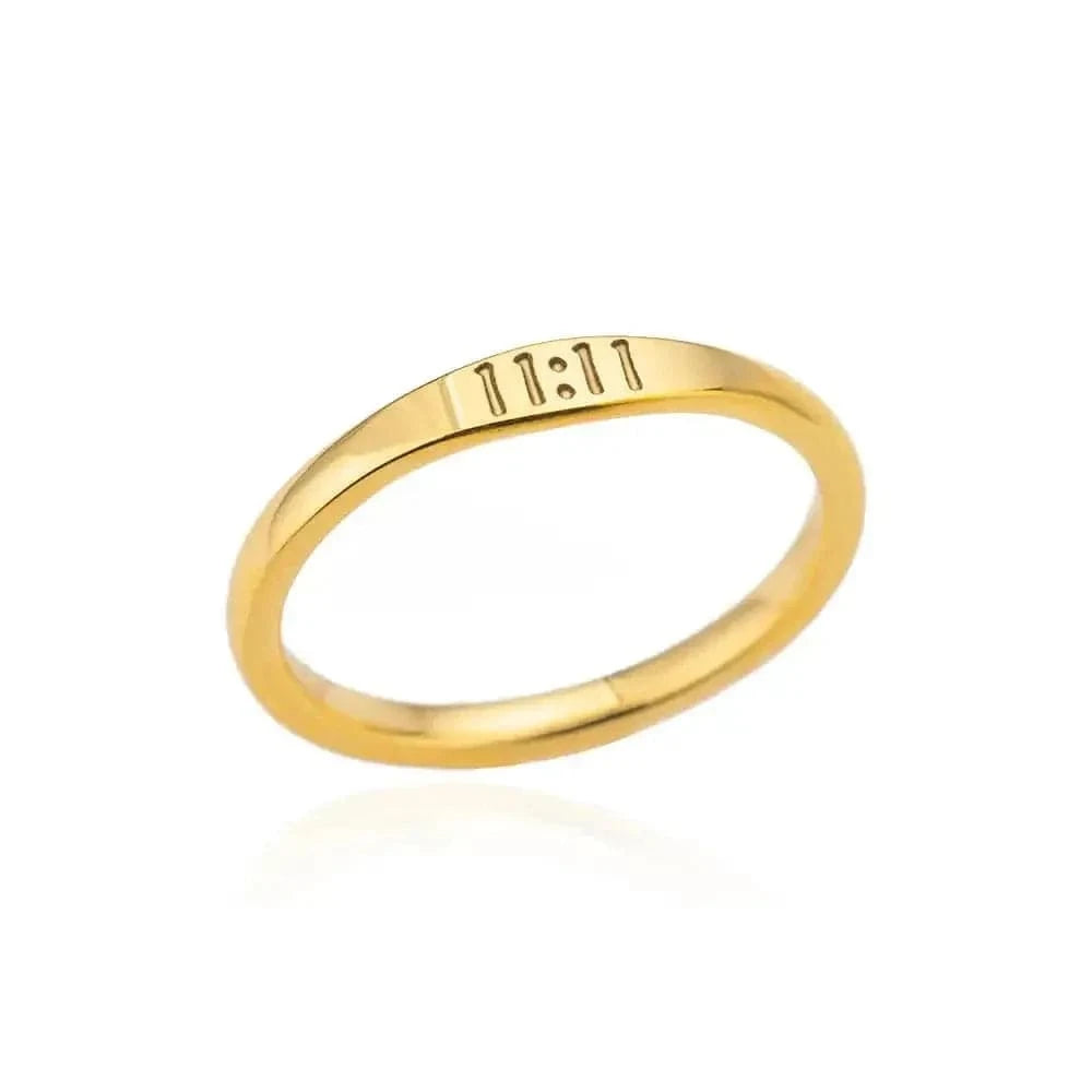 Gold ring with engraved text on a white background