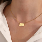 woman wearing gold 111 angel number pendant necklace — spiritual symbol jewelry for new beginnings