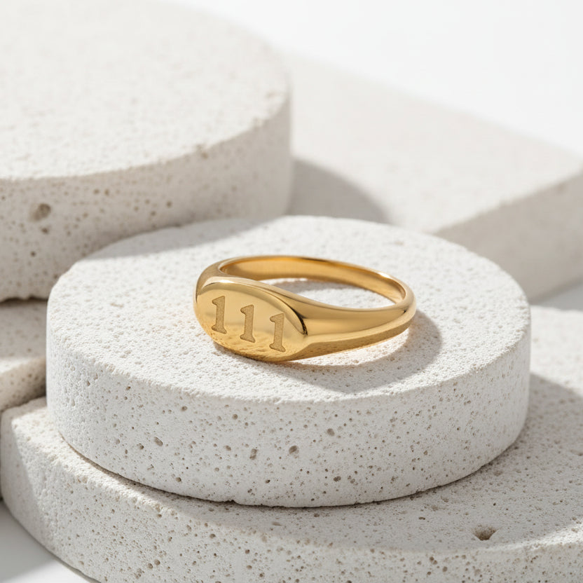 111_angel_number_ring_gold on a white background
