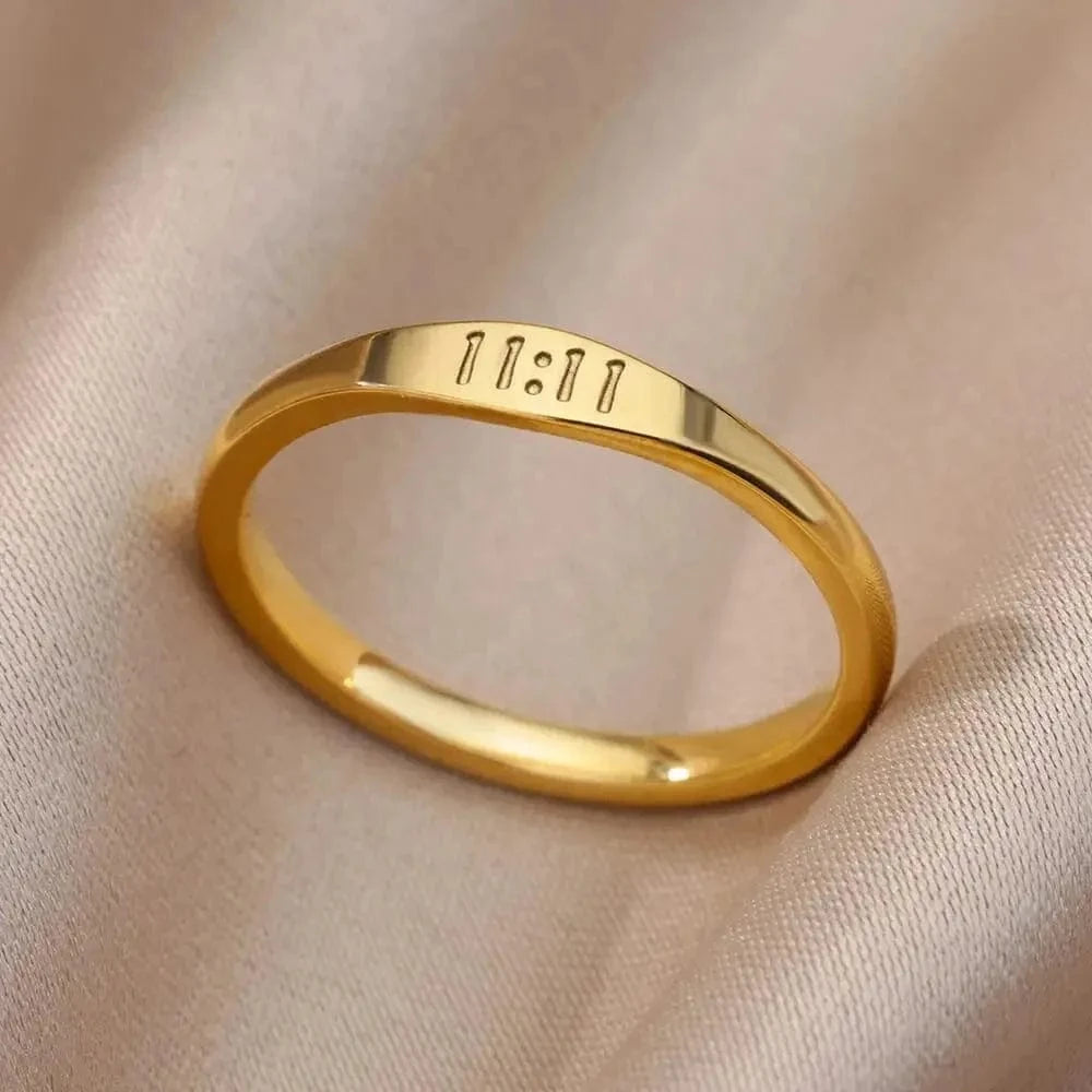 Gold ring with engraved numbers on a beige fabric background