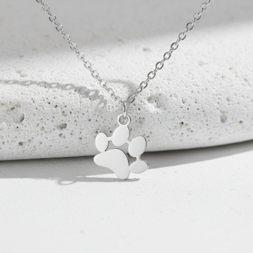 Silver necklace with a heart-shaped pendant on a white background