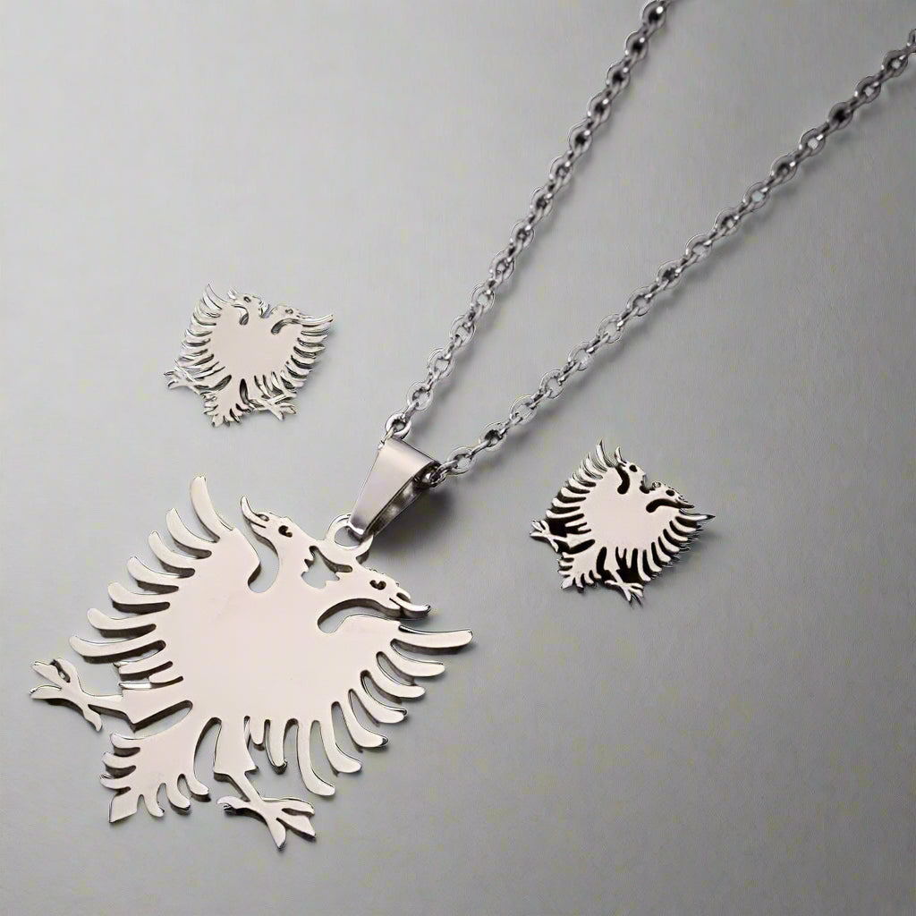 Silver eagle pendant and earrings on a black background