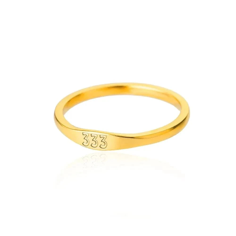 Gold ring with '333' engraving on a white background