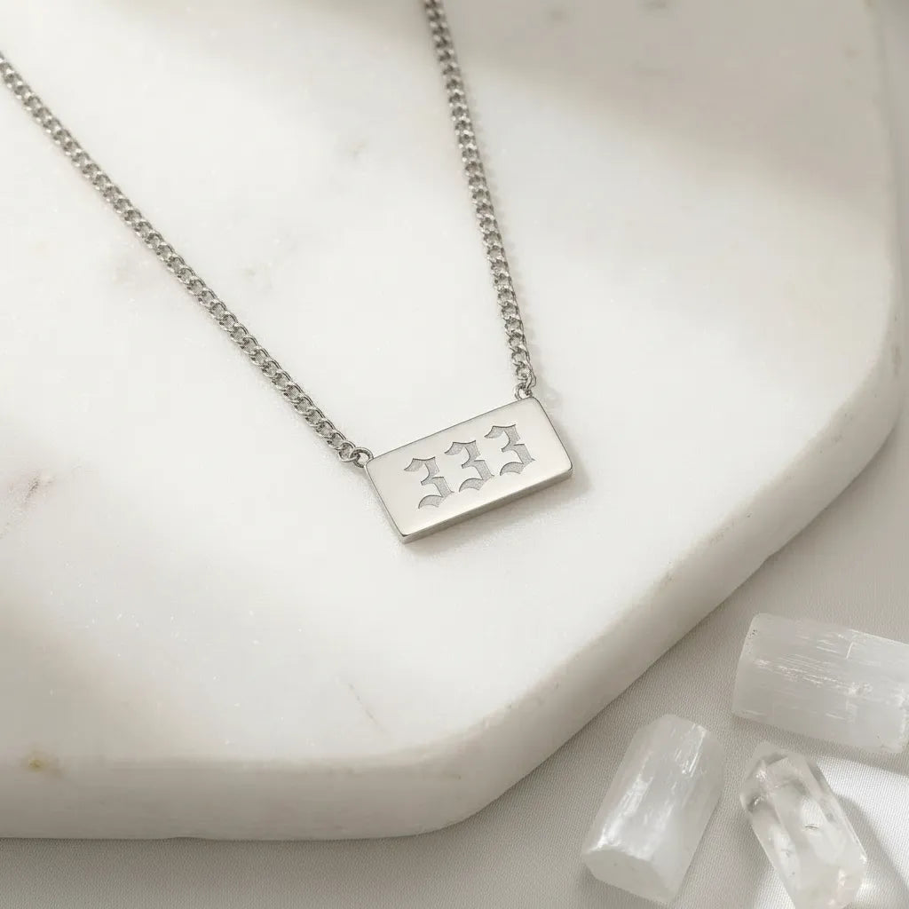 333 angel number rectangle pendant necklace with crystals on a light background