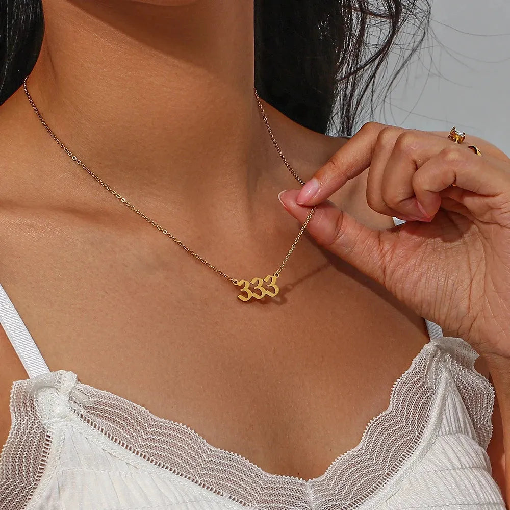 333 Gold angel number pendant necklaces  stainless steel, displayed on woman  