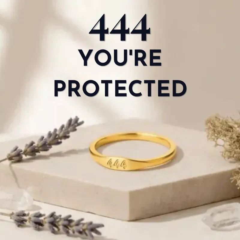 Gold ring on a beige box with lavender and gold leaves, text '444 YOU'RE PROTECTED' above.