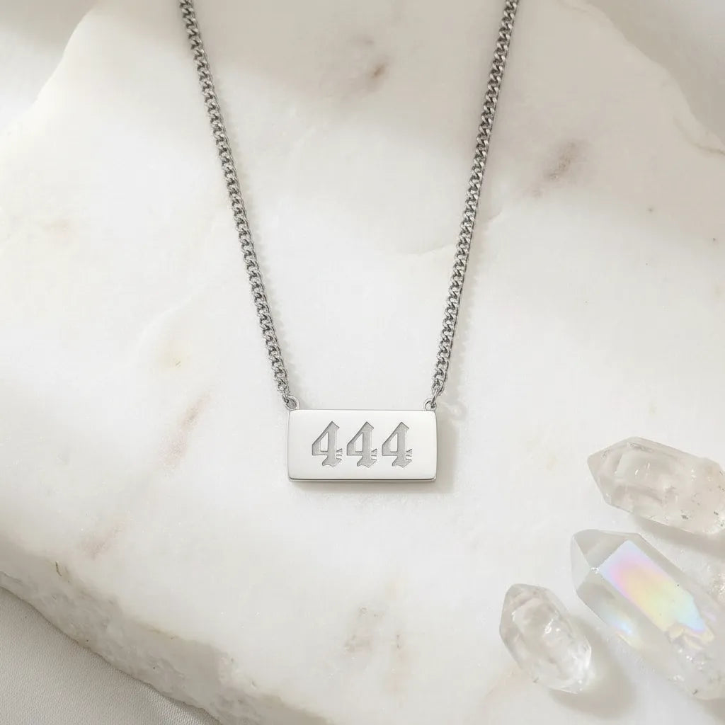 444 angel number rectangle pendant necklace with crystals on a light background