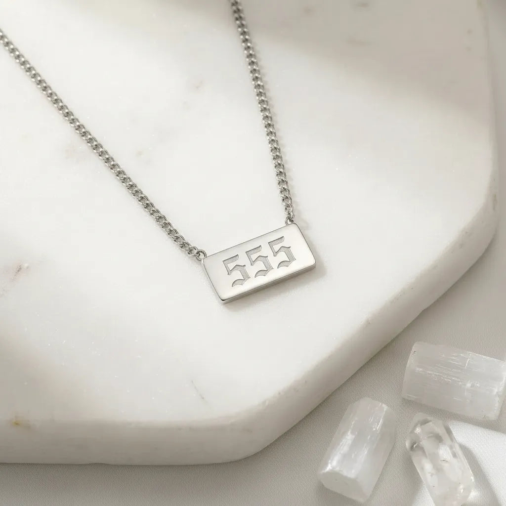 555 angel number rectangle pendant necklace with crystals on a light background