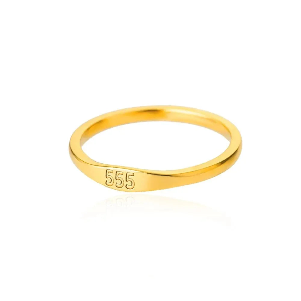 Gold ring with '555' engraving on a white background