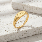 Gold ring with the number '555' on a white background