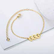 Gold bracelet with a unique clasp design on a white background