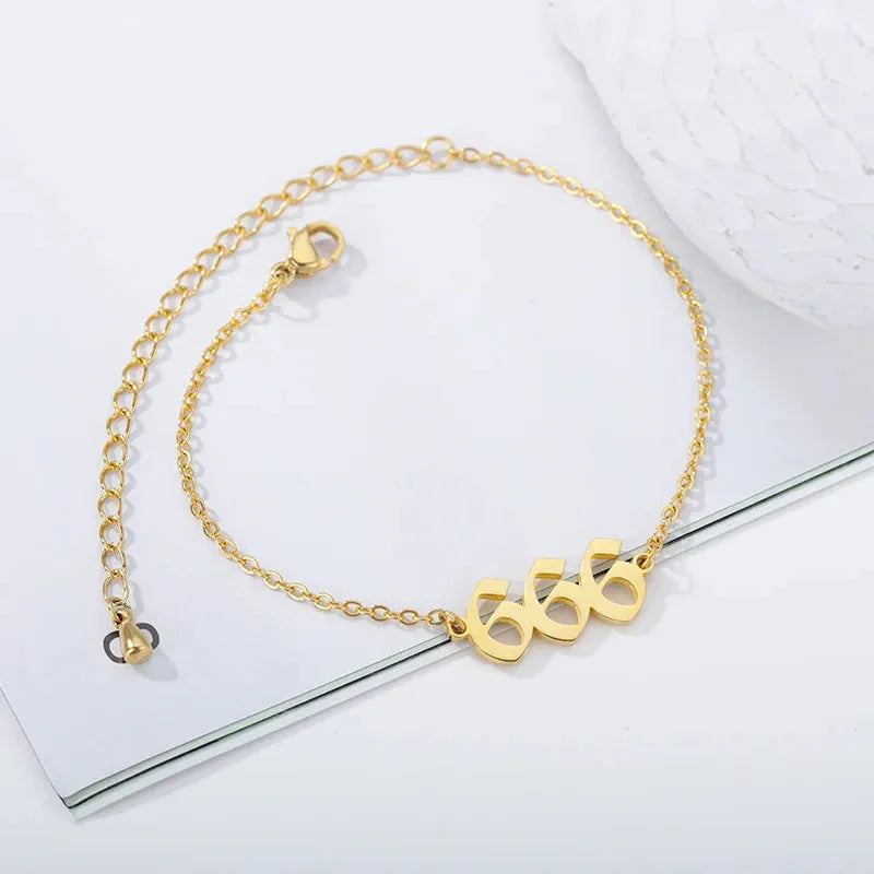 Gold bracelet with a unique clasp design on a white background