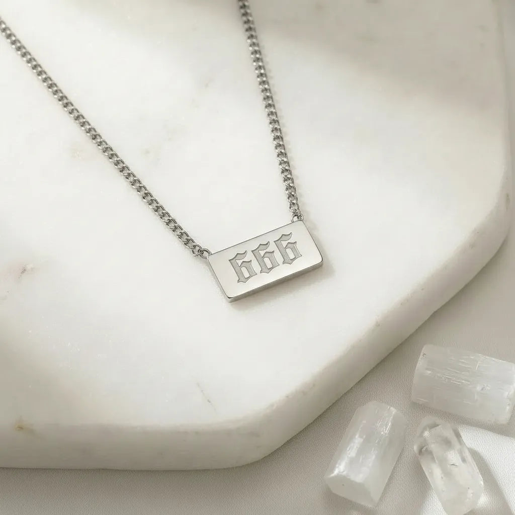 666 silver angel number rectangle pendant necklace with crystals on a light background