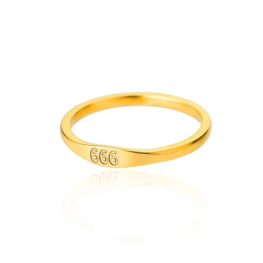 Gold ring with '666' engraving on a white background