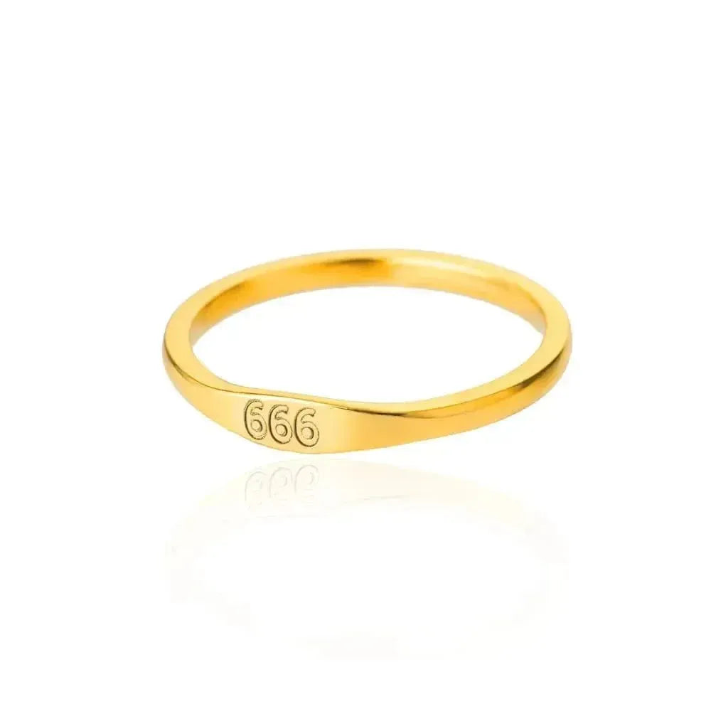 Gold ring with '666' engraving on a white background