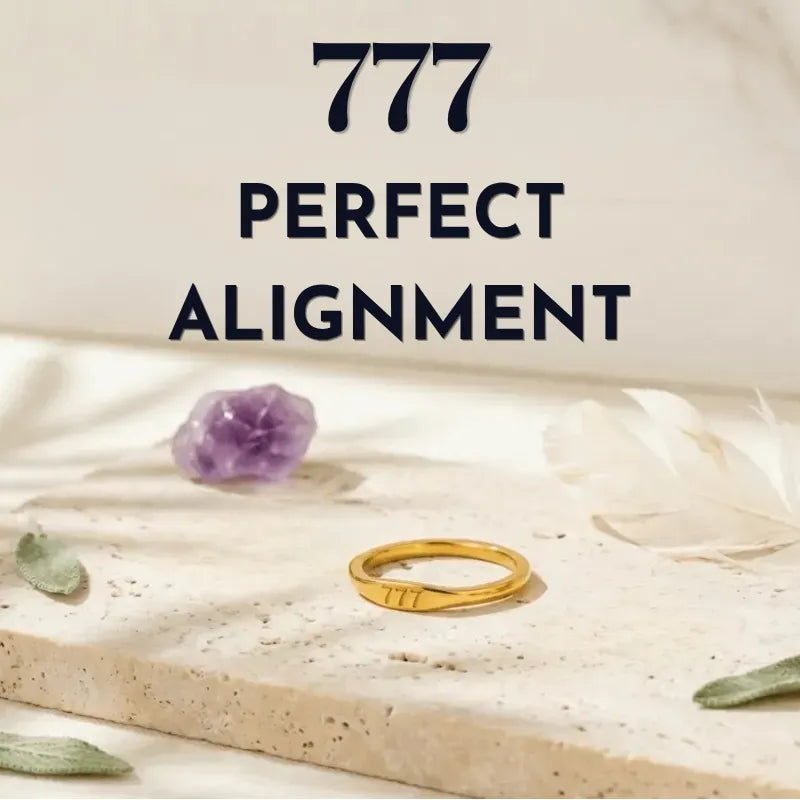 Gold ring and purple crystal on a white surface with '777 PERFECT ALIGNMENT' text.