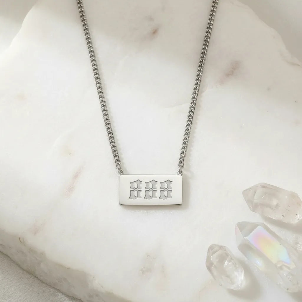 888 silver angel number rectangle pendant necklace with crystals on a light background