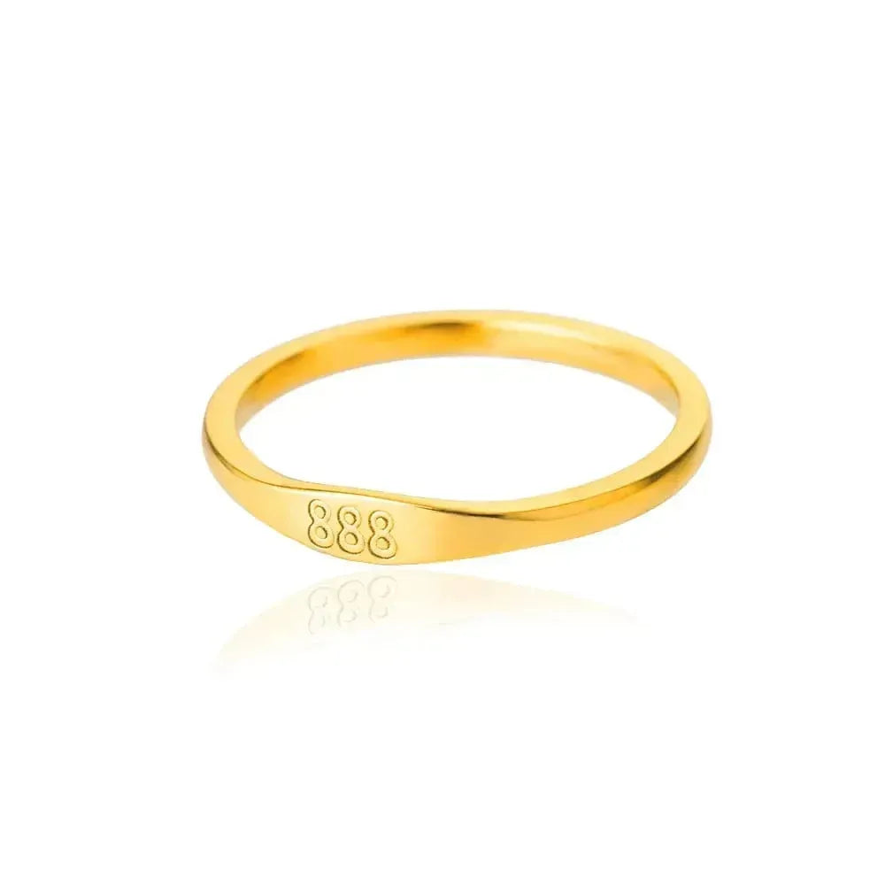 Gold ring with '888' engraving on a white background