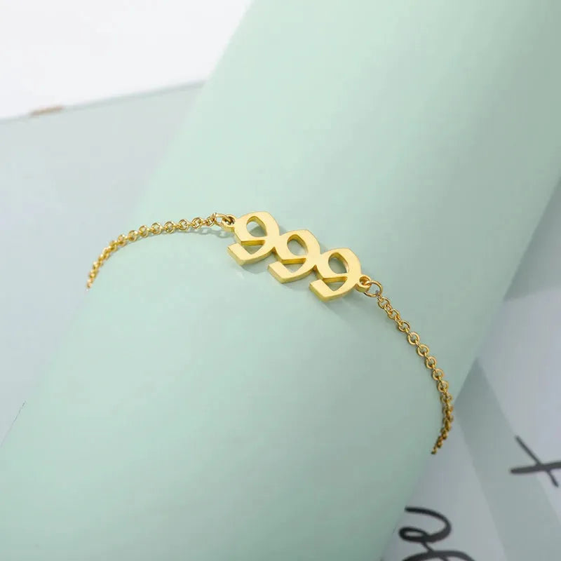 999 Gold bracelet on a light green surface