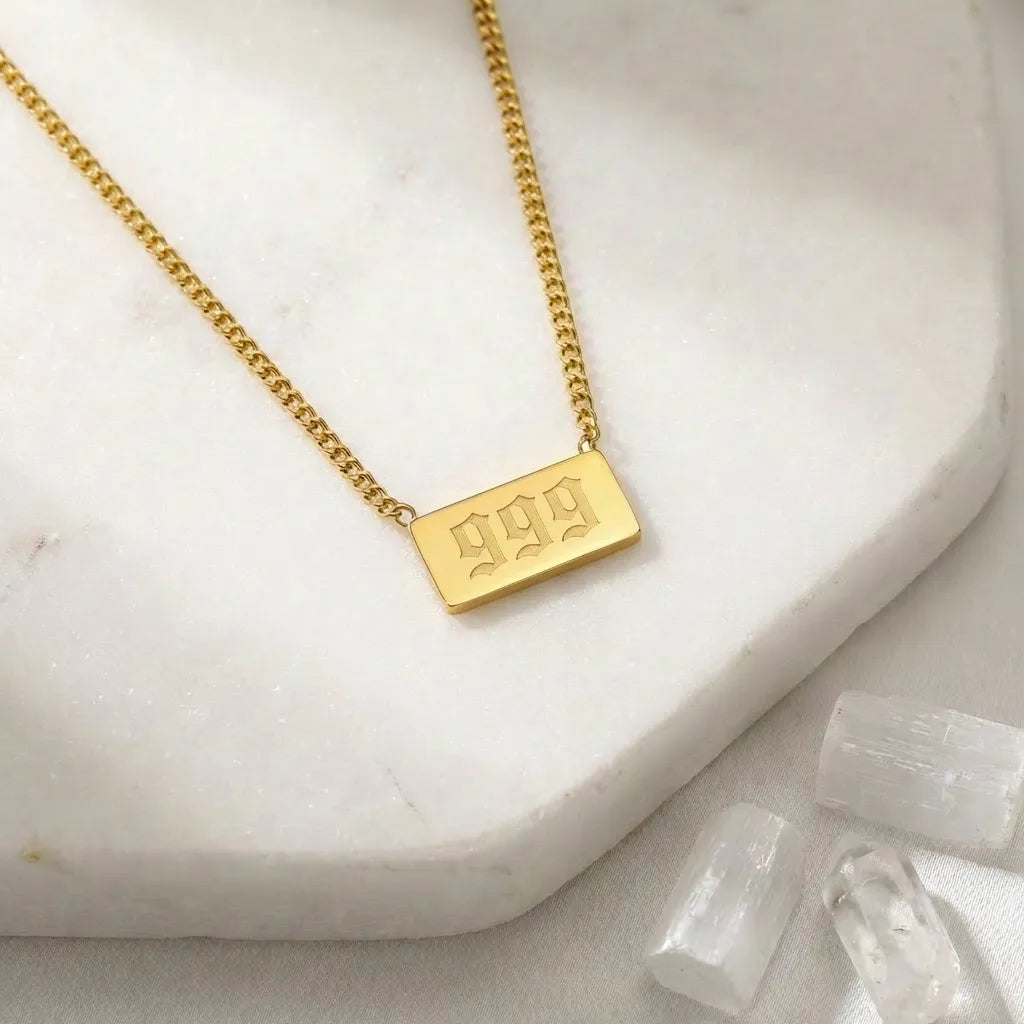 999 angel number rectangle pendant necklace with crystals on a light background