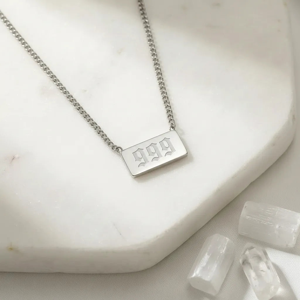 999 silver angel number rectangle pendant necklace with crystals on a light background