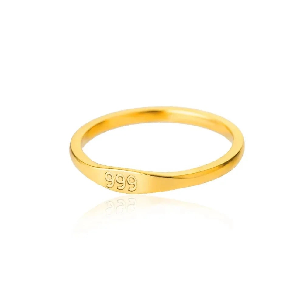 Gold ring with '999' engraving on a white background