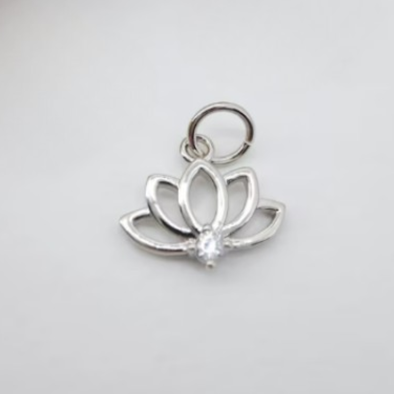 Symbol charm shown against a beaded crystal bracelet
