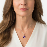 Woman wearing amethyst Athena teardrop pendant necklace in silver, February birthstone jewelry