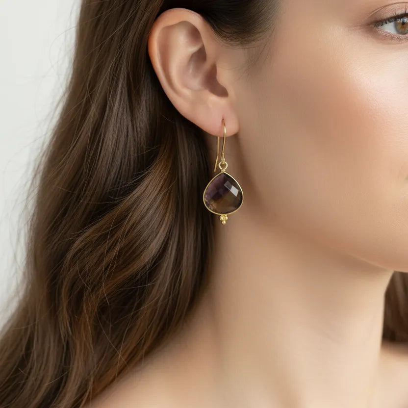 woman wearing gold ametrine drop earrings — crystal jewelry for balance and clarity