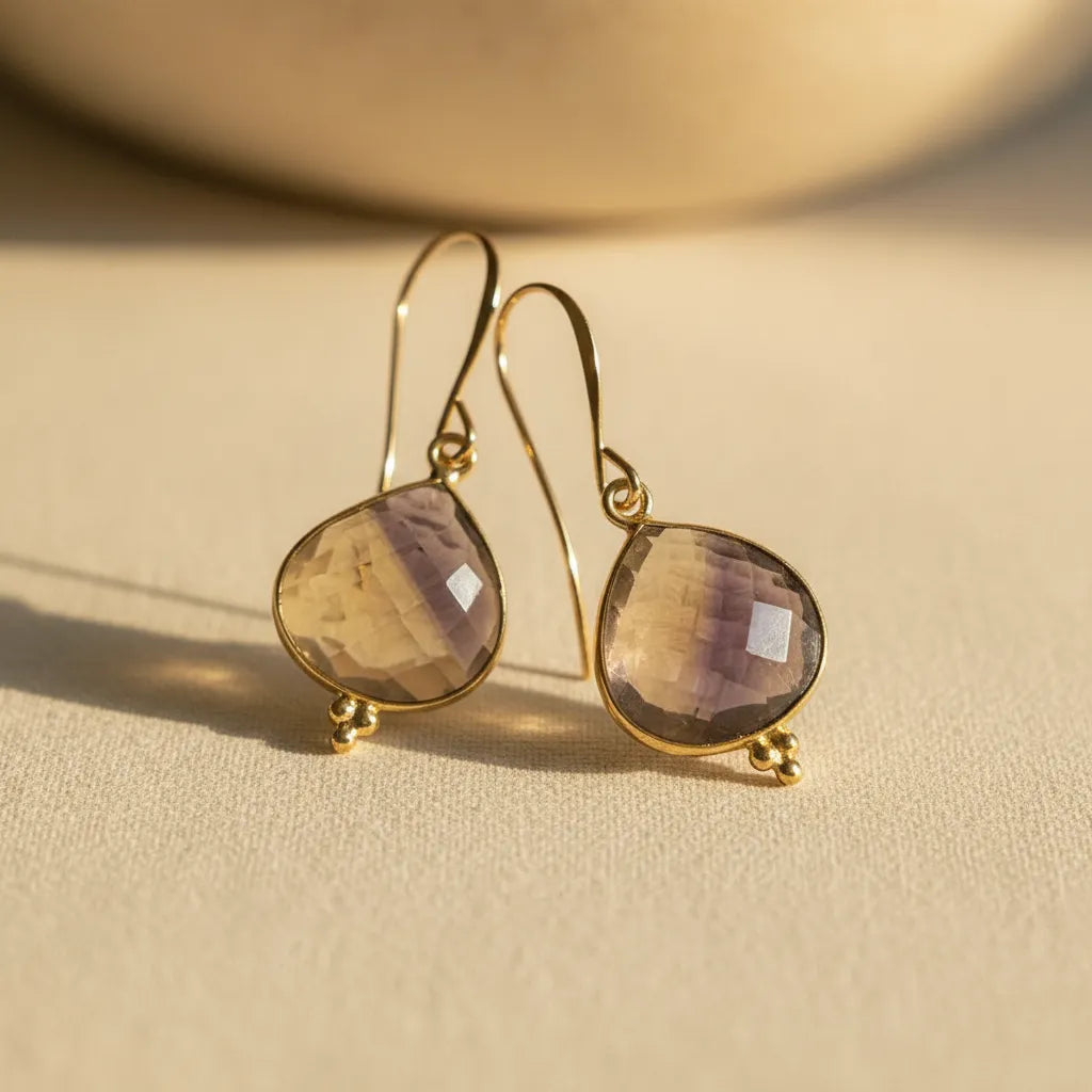 gold ametrine gemstone drop earrings close-up — crystal jewelry for balance