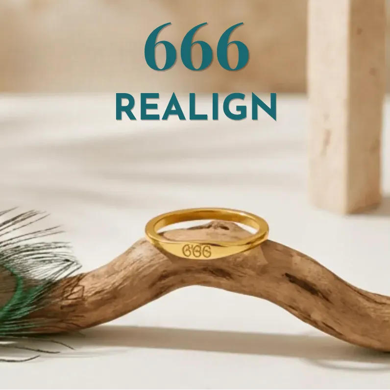 Gold ring with '666' engraving on a wooden branch with peacock feather, brand 'REALIGN' visible.
